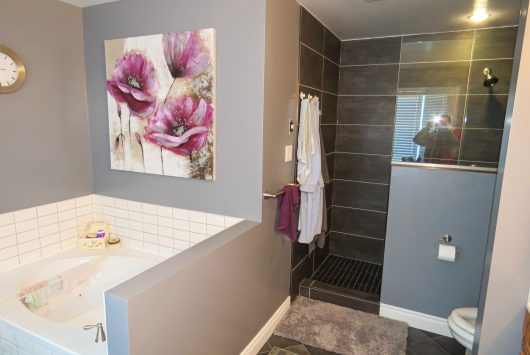 Modern double vanity bathroom renovation in Ottawa with custom wall panels