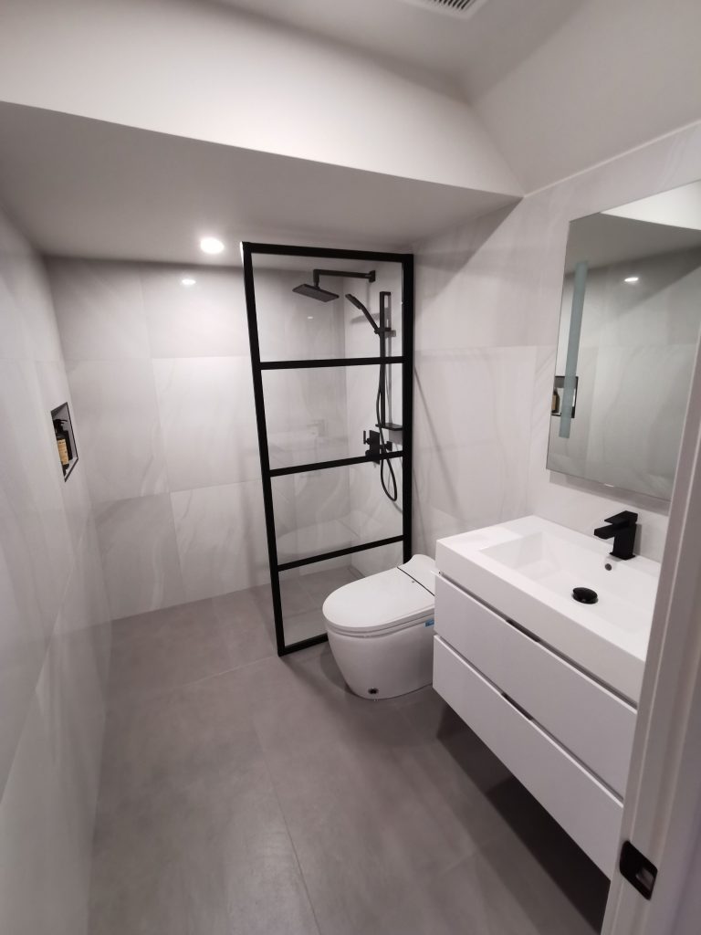 Small bathroom renovation with wall-mounted white vanity