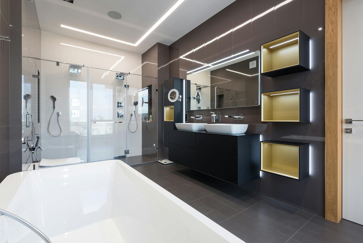 Contemporary bathroom with a double shower, black double vanity, bathtub and illuminated shelving